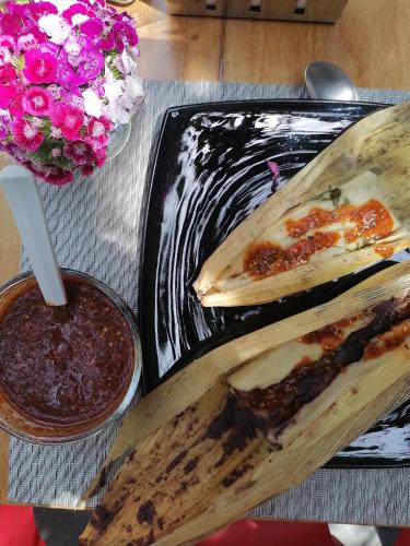 a table with a plate of food and a drink at Nardazul "Casa de Sueños" in Oaxaca City