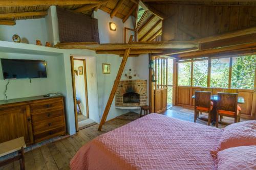 a bedroom with a bed and a fireplace at Hostal Renacer in Villa de Leyva