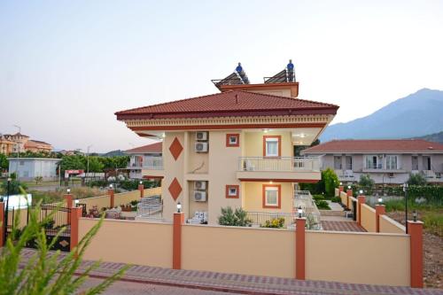 a house with a fence in front of it at can apart hotel in Kemer