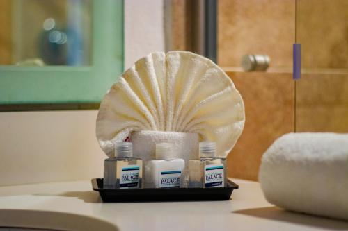 a bathroom with a shell and toiletries on a counter at Pacific Palace Beach Tower Hotel in Mazatlán