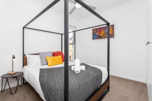 - une chambre avec un lit à baldaquin noir et blanc dans l'établissement 2 Chic Stylish Modern Family On Charles, à Perth