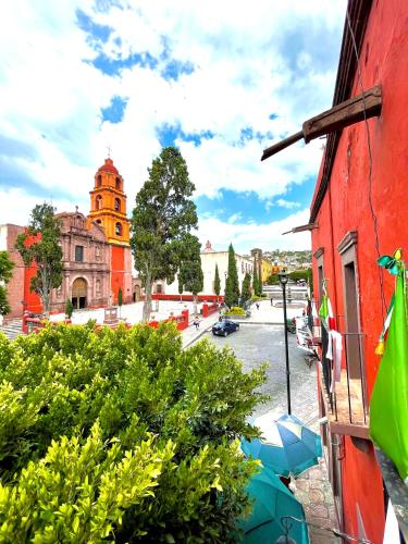 a view of a city street with a red building at Hotel Casa Oratorio "Adults Only" in San Miguel de Allende
