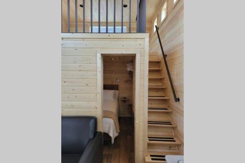 a room with a bed and stairs in a house at 073 Tiny Home nr Grand Canyon South Rim Sleeps 8 in Valle