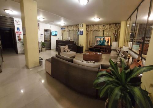 a large living room with couches and a couch at La Merced Plaza Hospedaje in Riobamba