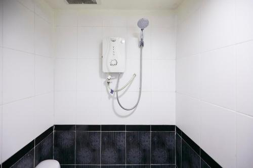 a bathroom with a shower with a phone on the wall at Fast Hotel Setapak in Kuala Lumpur