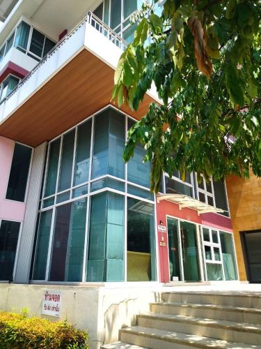 a school building with stairs in front of it at Duplex 21 Apartment in Bangkok