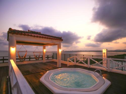 a hot tub on a deck with a gazebo at Haruhoo Resort ISHIGAKI in Ishigaki Island