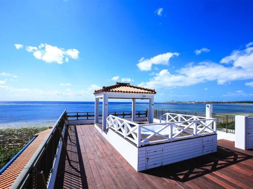 a gazebo on a pier next to the beach at Haruhoo Resort ISHIGAKI in Ishigaki Island