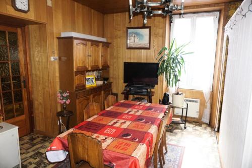 a dining room with a table and a television at Appartement spacieux à 15 minutes de Valfrejus - 2 Pièces 4 personnes MAE-1596 in Modane
