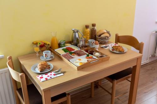 un tavolo di legno con piatti di cibo sopra di Apartments Repinc a Bled