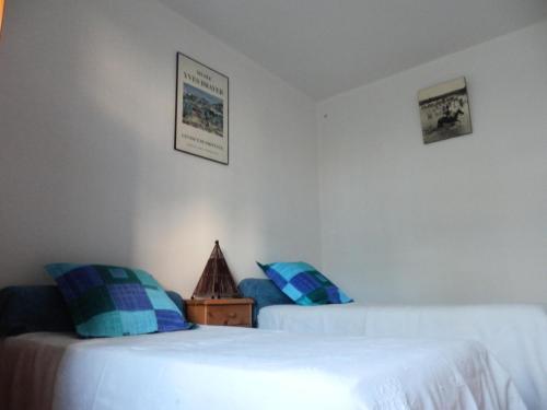 - une chambre avec 2 lits dotés d'oreillers bleus dans l'établissement Appartement 3 pièces 4 personne centre village - 3 Pièces 4 personnes MAE-7788, à Saintes-Maries-de-la-Mer