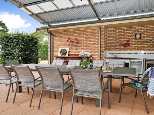 a patio with a table and chairs and a grill at Misty Creek of Robertson in Robertson