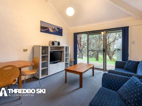 a living room with a couch and a table at Kirkwood 4 in Thredbo