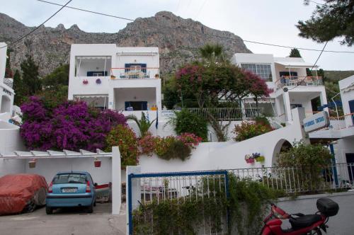 a house with a car parked in front of it at Tatsis Apartments in Masouri