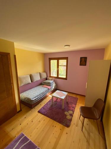 a living room with a couch and a table at Apartman Mijovic - Nova Varos in Nova Varoš