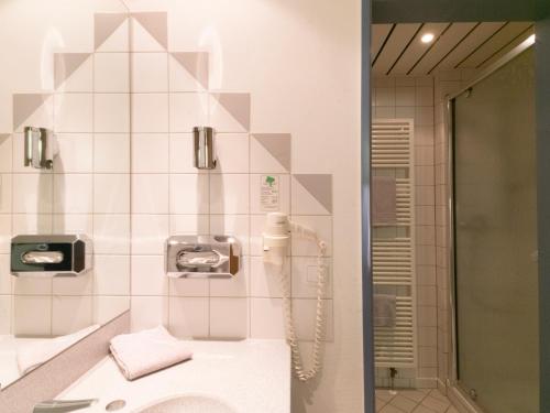 a bathroom with a shower and a sink at Hotel am Stadtpark in Borken