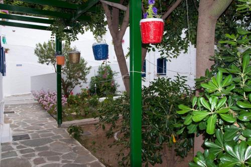 a garden with colorful lanterns hanging from a building at Tatsis Apartments in Masouri