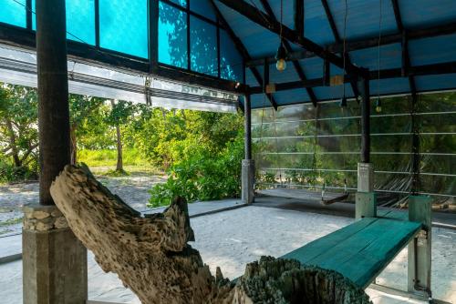 a wooden bench sitting inside of a building at Mi Lugar Maldives in Nolhivaranfaru