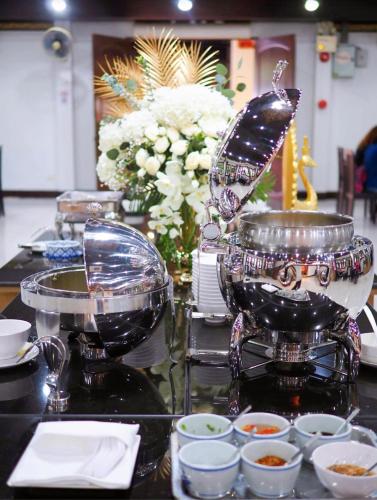 a buffet of food with a butterfly on a table at Luckswan Resort Chiang Rai - SHA Extra Plus in Chiang Rai