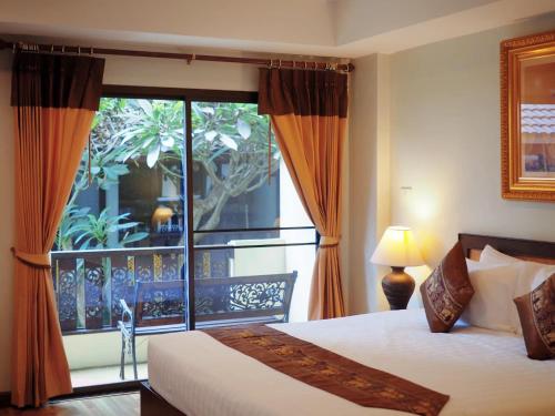 Rúm í herbergi á Luckswan Resort Chiang Rai - SHA Extra Plus