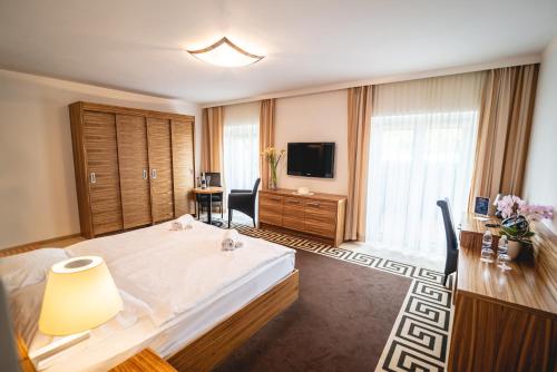 a hotel room with a bed and a television at Casino & Hotel ADMIRAL Kozina in Kozina