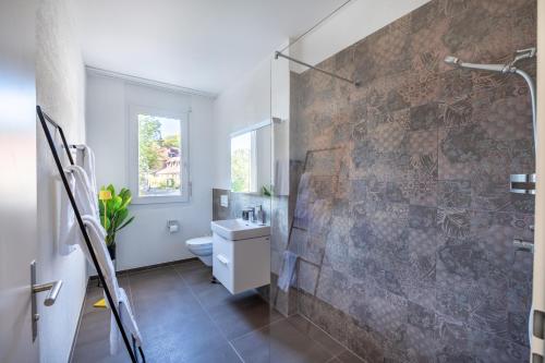 uma casa de banho com uma parede de pedra e um chuveiro em Monardo Hasenberg em Widen