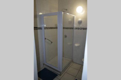 a shower with a glass door in a bathroom at 3 Eden Sands in Kingsburgh