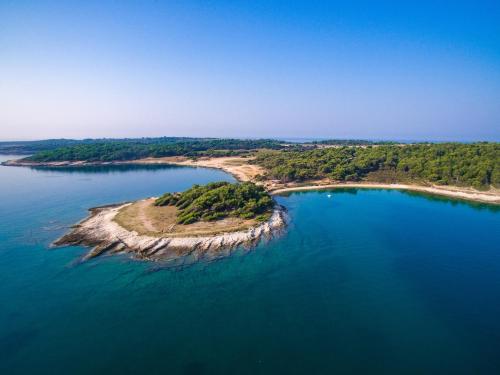 an island in the middle of a body of water at Holiday house Vedrana, Jadreški in Pula