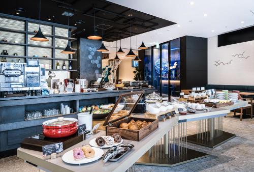 a bakery with a buffet of food on display at The Royal Park Canvas - Kobe Sannomiya in Kobe