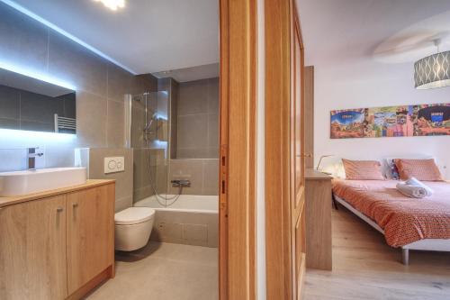シャモニー・モンブランにあるApartment Picassoのベッドルーム1室(ベッド1台付)、バスルーム(バスタブ付)が備わります。