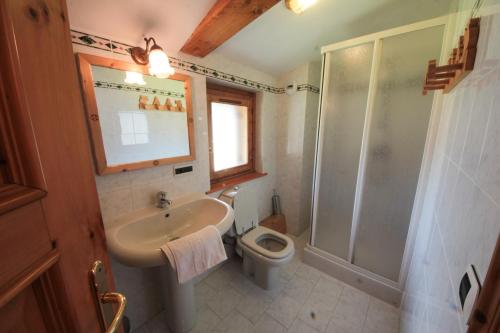 a bathroom with a sink and a shower and a toilet at Apartment Beauregard in Les Houches