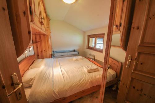 a small bedroom with a bed and a window at Apartment Beauregard in Les Houches