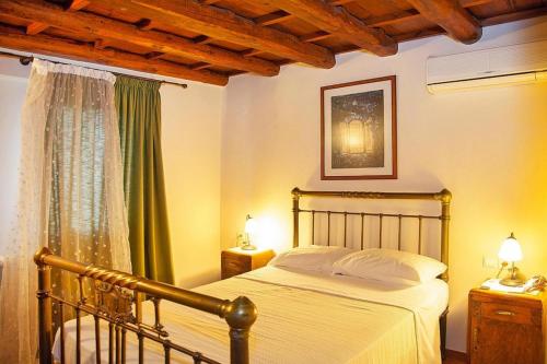 a bedroom with a bed and two lamps and a window at Vacation home in the Archanes with balcony in Archanes
