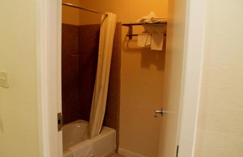 a bathroom with a shower with a shower curtain at Best Way Inn and Suites - New Orleans in New Orleans