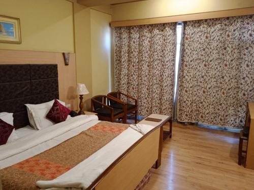 Ένα ή περισσότερα κρεβάτια σε δωμάτιο στο Hotel New Mamta
