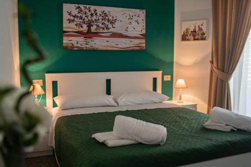 1 dormitorio verde con 1 cama con 2 almohadas en Ai Giudici, en Palermo