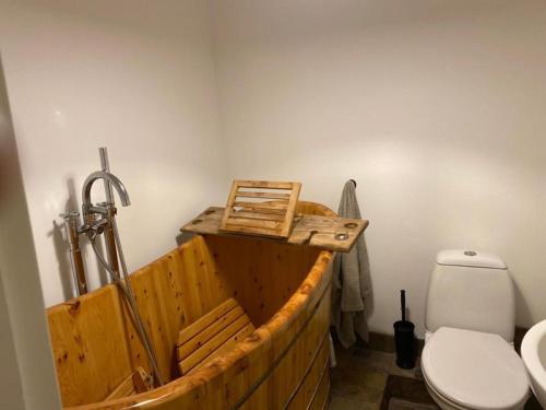 a wooden bath tub with a toilet in a bathroom at 2-Bed Cottage in in Welsh Valley Nr Swansea in Swansea