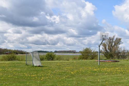 a basketball hoop and a goal in a field at Kerteminde Byferie - Hyrdevej 83, 85K in Kerteminde