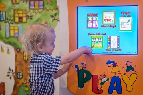 a young child playing with a toy play station at Alpenhotel Enzian in Mönichkirchen