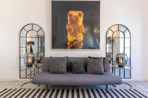 a living room with a couch and a picture of a dog at Portas do Céu Apartments in Lisbon