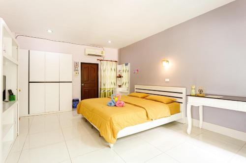 um quarto com uma cama com lençóis amarelos e uma cozinha em Pennaung Resort em Bung Kan