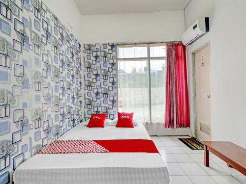 Ένα ή περισσότερα κρεβάτια σε δωμάτιο στο OYO 90621 Pondok 23