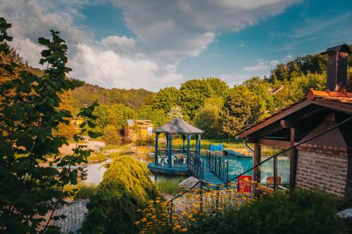 a swimming pool with a gazebo in a garden at Stará střelnice Hranice in Hranice