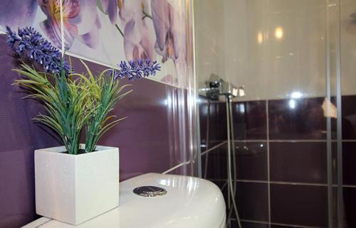 a bathroom with a toilet and a vase with flowers on it at Cascata do Varosa - Turismo Rural in Vila Pouca