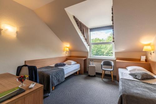 Säng eller sängar i ett rum på Hotel Sigulda
