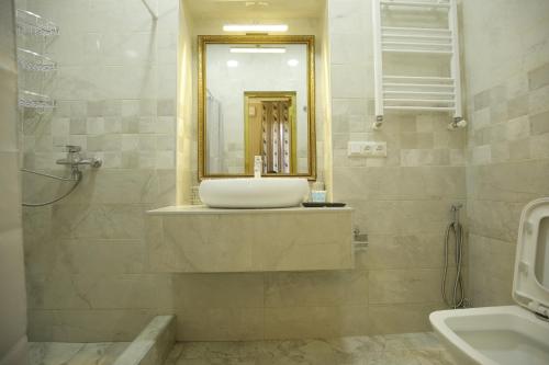 a bathroom with a sink and a mirror at HOTEL COMFORT in Kutaisi