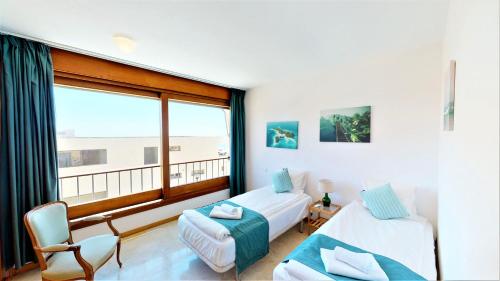 A bed or beds in a room at Lomas de los Monteros - Apartment with seaviews