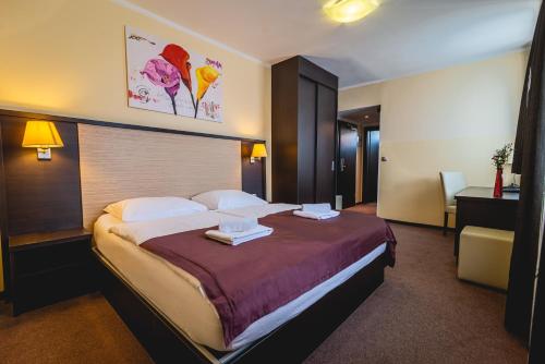 Postel nebo postele na pokoji v ubytování Casino & Hotel ADMIRAL Ptuj
