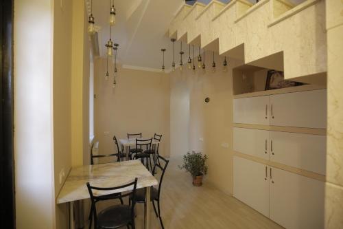 a dining room with a table and some chairs at HOTEL COMFORT in Kutaisi