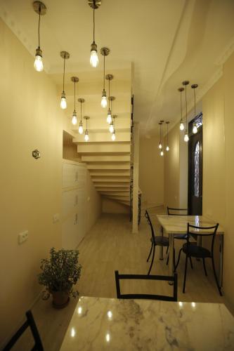 a dining room with a table and chairs and lights at HOTEL COMFORT in Kutaisi